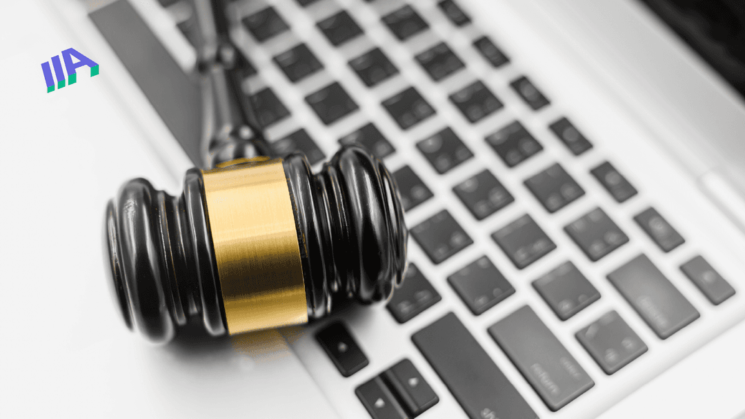 Close-up of a judge’s gavel resting on a laptop keyboard, symbolizing digital legal issues or website compliance.