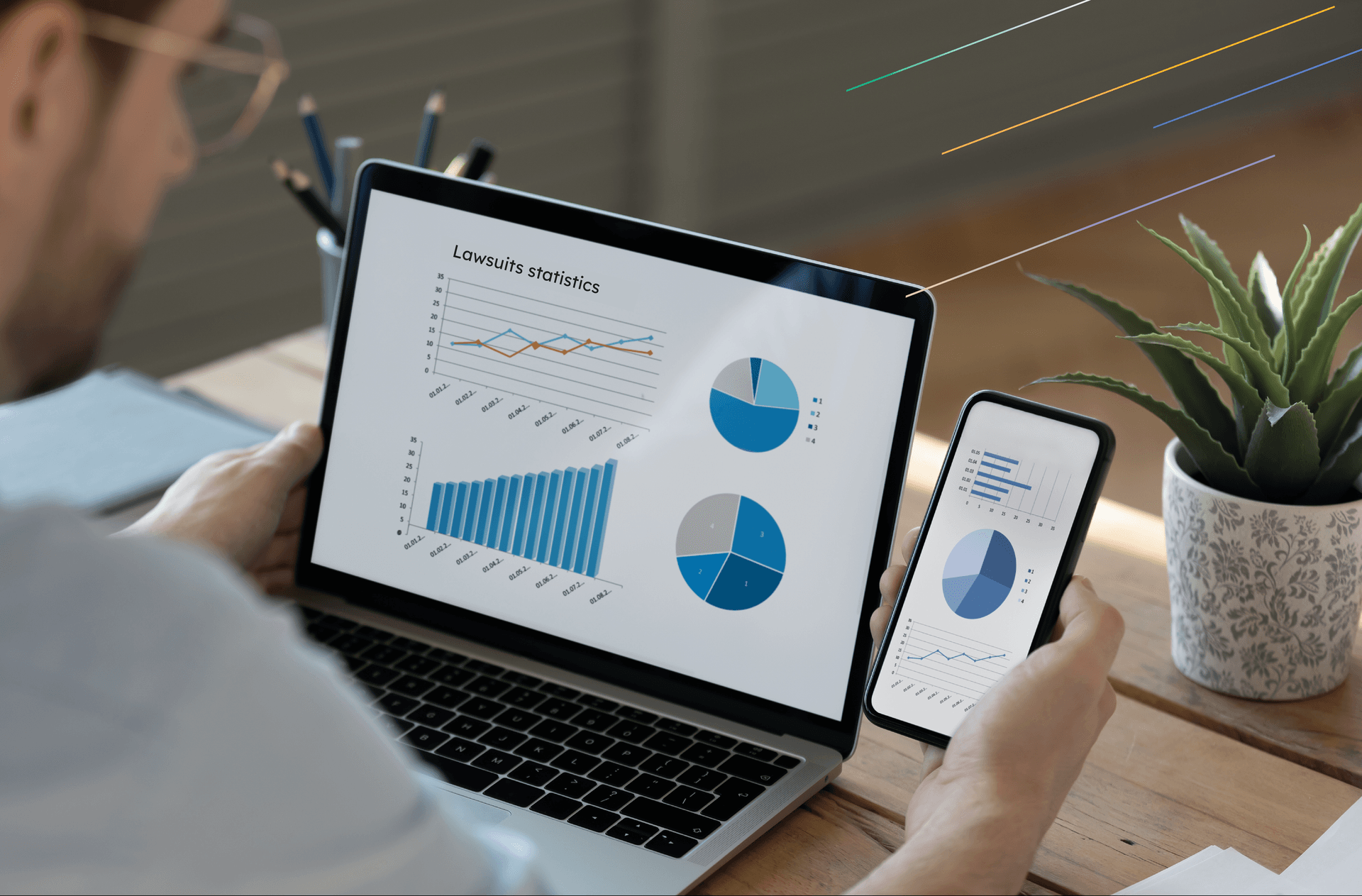 a man in glasses is sitting with laptop and smartphone reviewing accessibility lawsuits statistics report