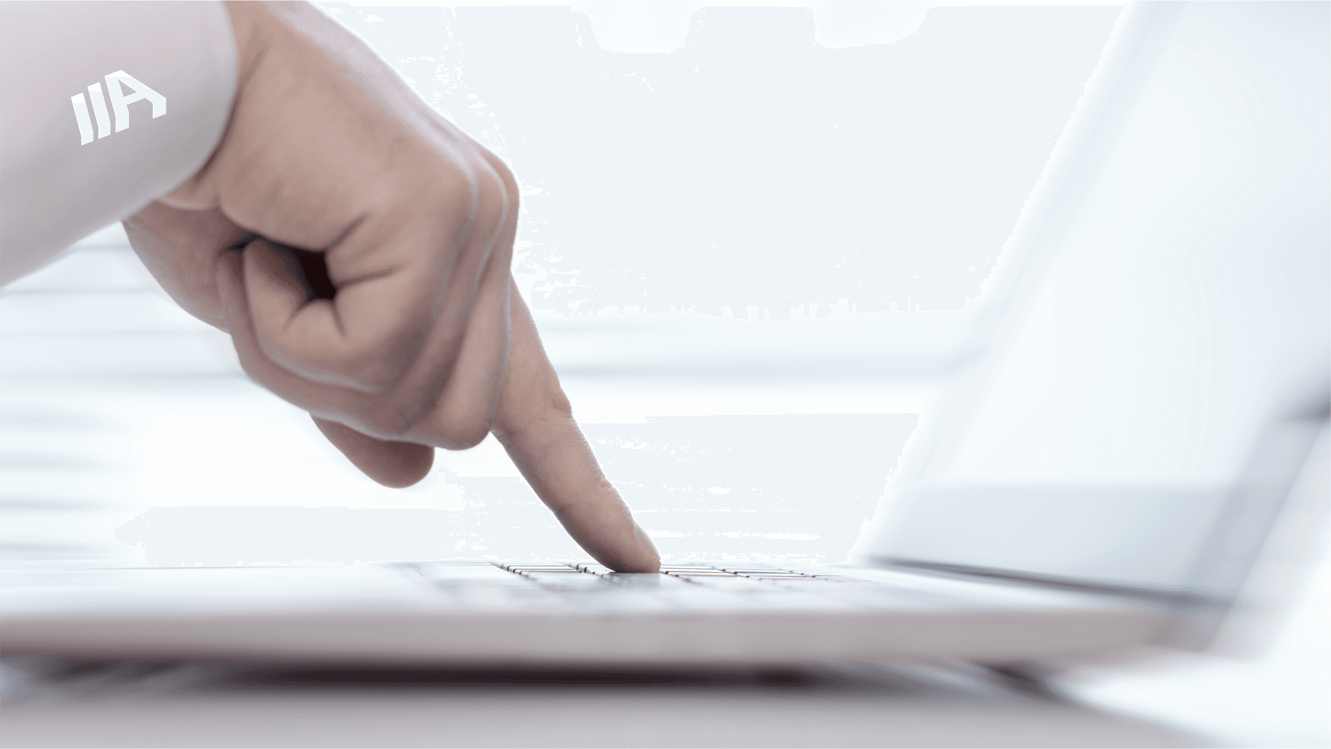 A close-up of a hand pressing a key on a laptop keyboard, symbolizing digital interaction and accessibility.