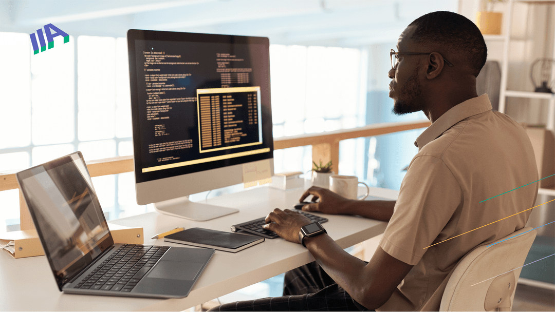 a man sits in front of a computer, analyzing website code