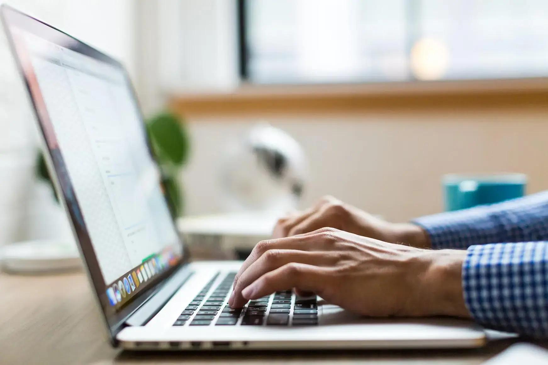a person is working on a laptop fixing accessibility of the site